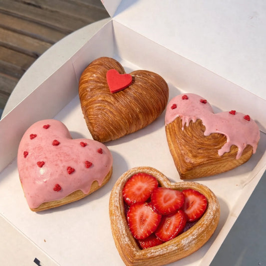 Heart shaped pastries and desserts made with stainless steel heart pastry ring with strawberries and glaze in bakery box