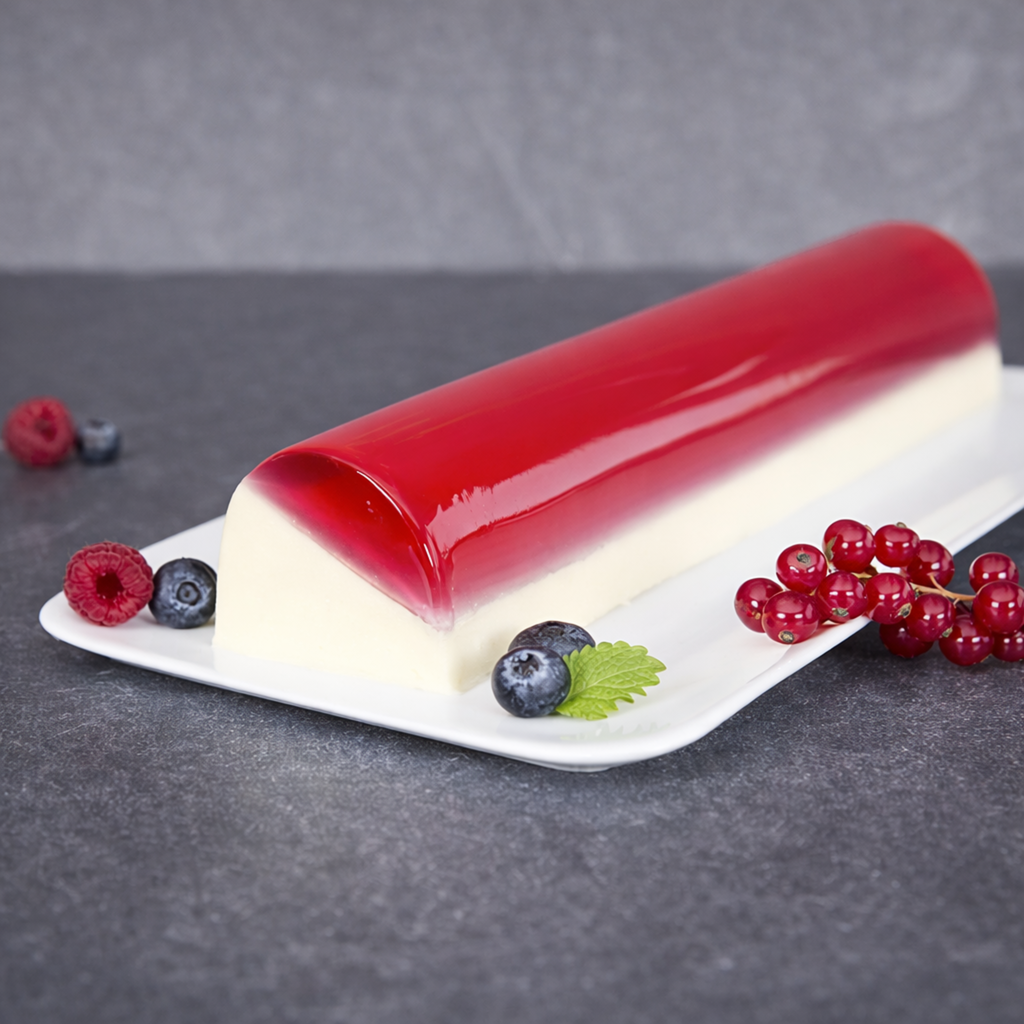Elegant layered berry mousse dessert created using the Maximov semicircle stainless steel mold. Shows perfect smooth curvature for pastry.