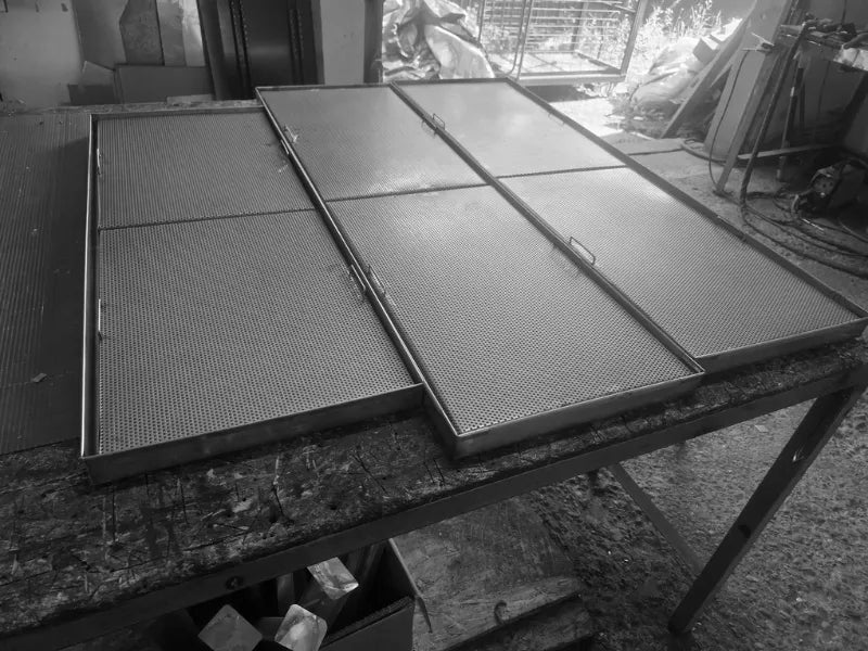Perforated stainless steel drip trays AISI 304 600x400 mm in workshop setting
