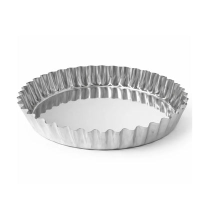 Side view of an empty stainless steel fluted tart mold for professional baking.
