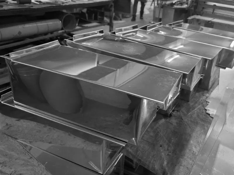 Stainless steel Pullman loaf pans with lids in production batch for professional baking