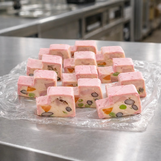 Layered terrine slices made with stairs shape stainless steel terrine mold on kitchen work surface