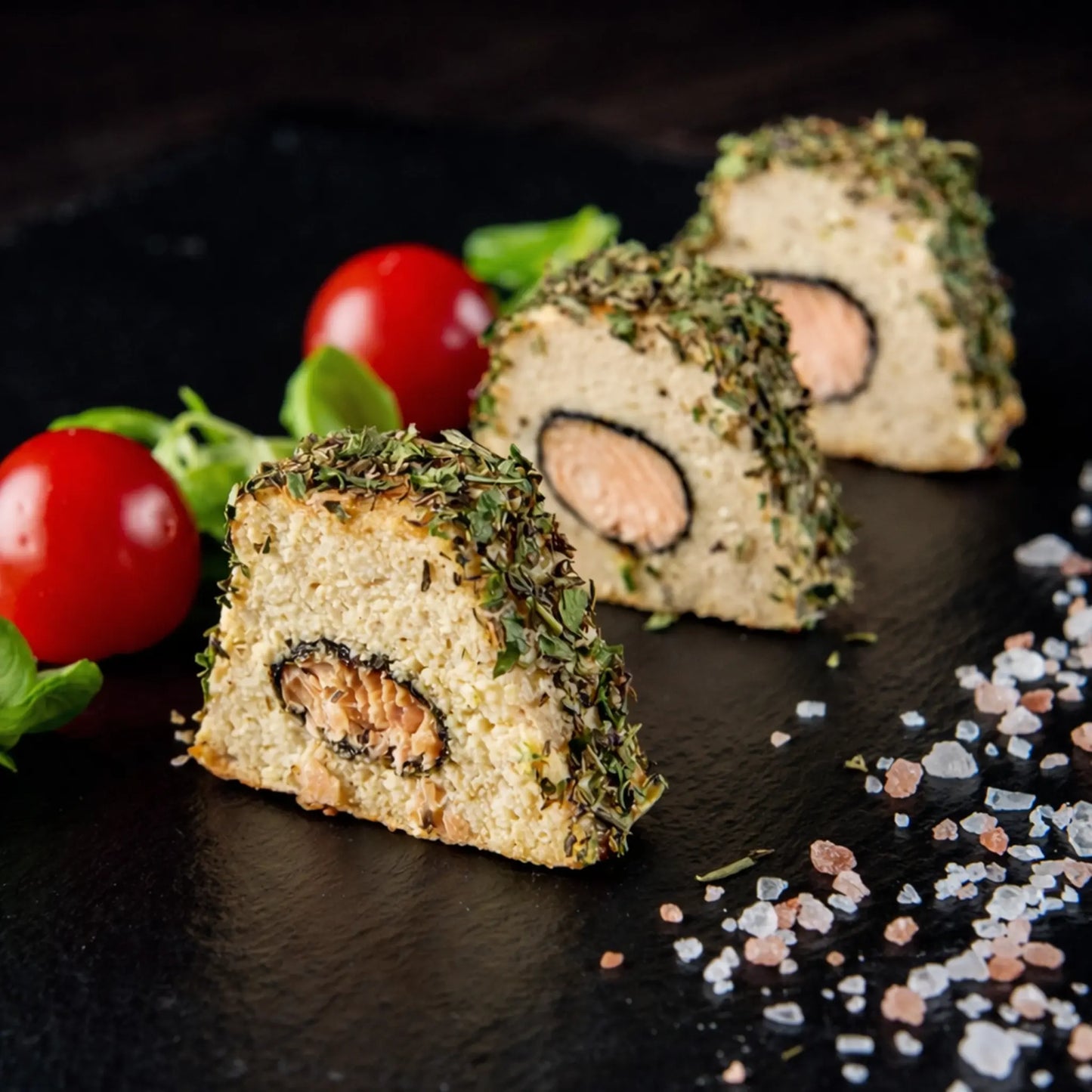 Gourmet herb-crusted salmon pate slices with a perfect trapezoidal shape, prepared using a professional stainless steel terrine mold for Horeca.