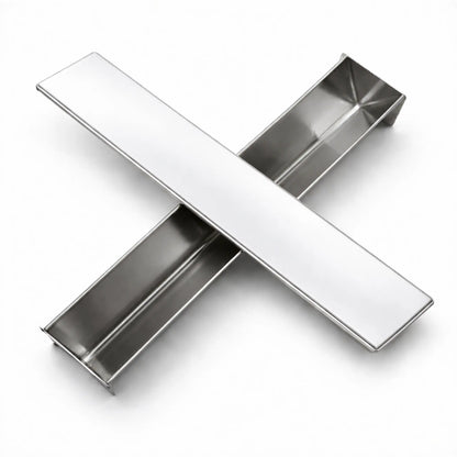 Professional stainless steel V-Shape terrine mold and its flat lid crossed on a white background, designed for making triangular pâté and desserts