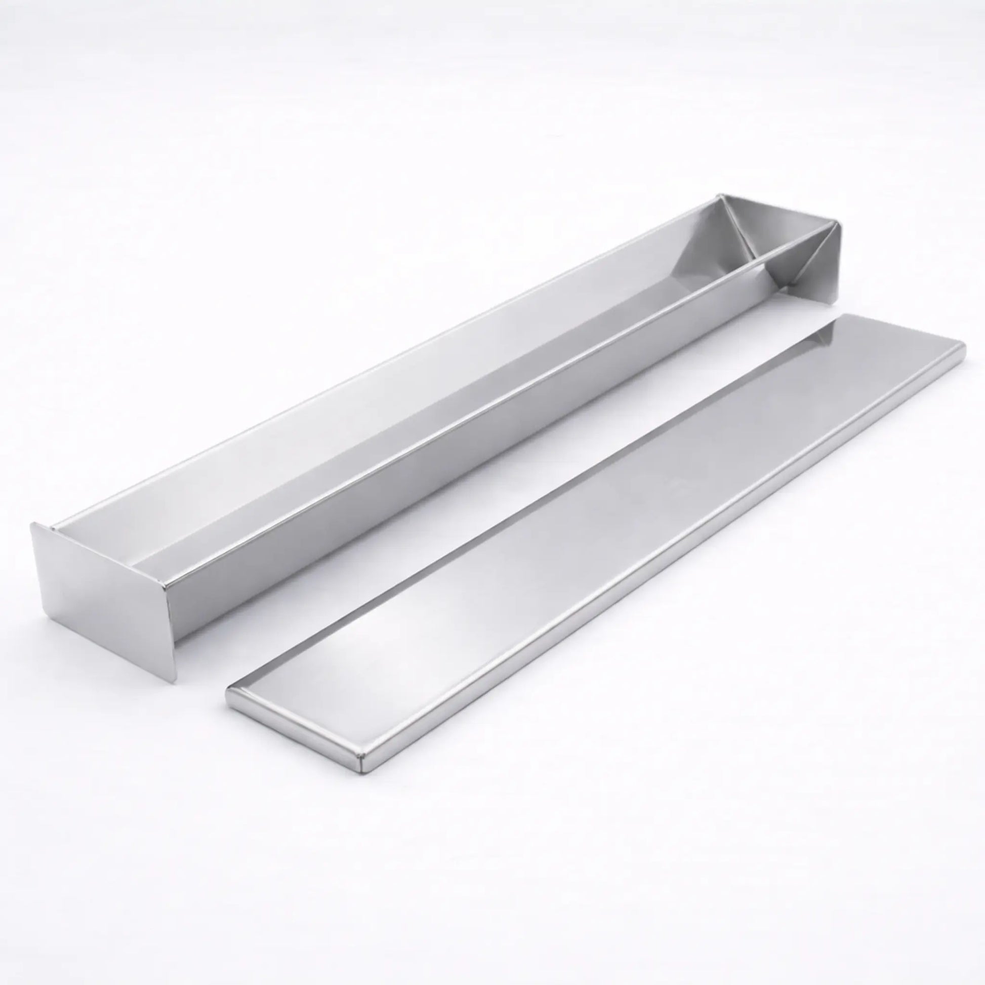Empty professional stainless steel V-Shape terrine mold resting next to its matching flat lid on a white background, used for triangular shaped foods