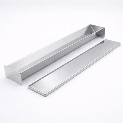 Empty professional stainless steel V-Shape terrine mold resting next to its matching flat lid on a white background, used for triangular shaped foods